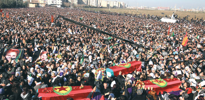 A general view shows thousands of Kurds shouting slogans and carrying the coffins of three Kurdistan Workers Party (PKK) members killed in France, dur