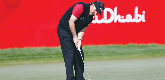 Phil Mickelson of the US watches the ball on the 18th green during the Abu Dhabi Golf championship. (Reuters)