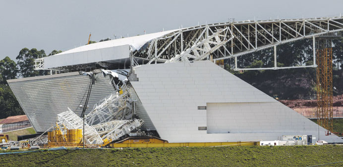 A portion of the Sao Paulo stadium is damaged after a crane fell across part of the metallic structure yesterday.