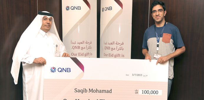 Saqib Mohamed with a QNB official.