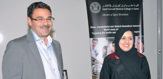 WCMC-Q Associate Dean for Research Professor Khaled Machaca presents certificate to Dr Najla al-Haj.