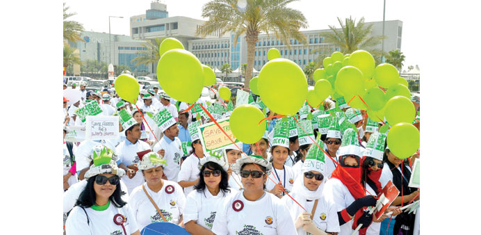 GO GREEN: A section of the participants holding green balloons.