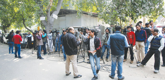 Reporters and cameramen stand outside the main gate of the residence of Tarun Tejpal in New Delhi yesterday.