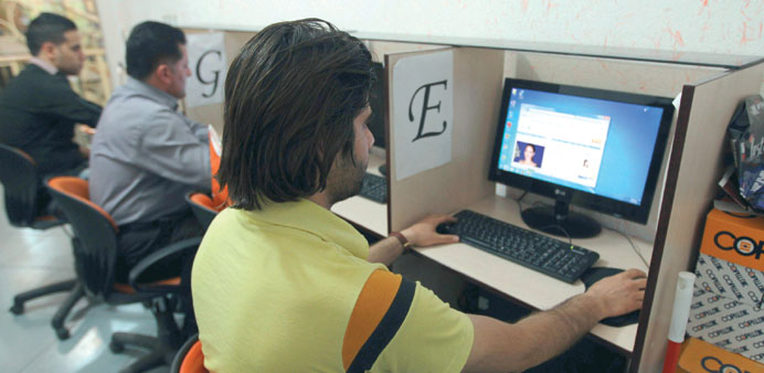 People using the Internet at a cyber cafe in Tehran.