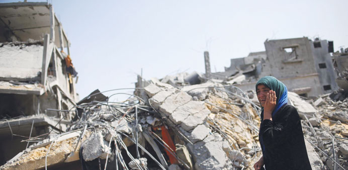 A woman cries on seeing her destroyed house in Beit Hanoun town in the northern Gaza Strip yesterday.
