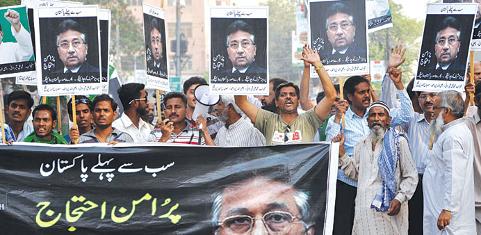 Supporters of former president Pervez Musharraf hold banner reading in Urdu u2019Peaceful Protestu2019 as they shout slogans
