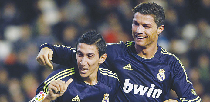 Real Madridu2019s Angel Di Maria (L) celebrates with teammate Cristiano Ronaldo after he scored against Valencia during their Spanish first division socce