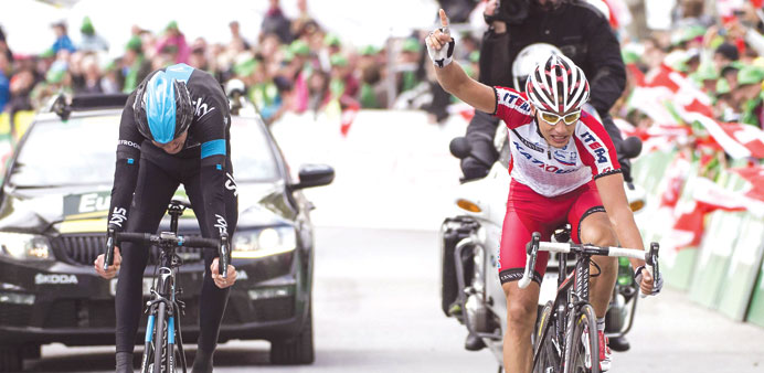 Slovenian cyclist Simon Spilak (right) of team Katusha celebrates after crossing the finish line to win the third stage ahead British Christopher Froo