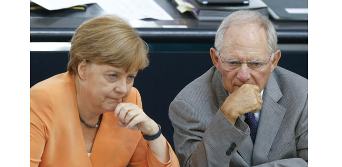  Chancellor Merkel speaks with finance minister Wolfgang Schaeuble.