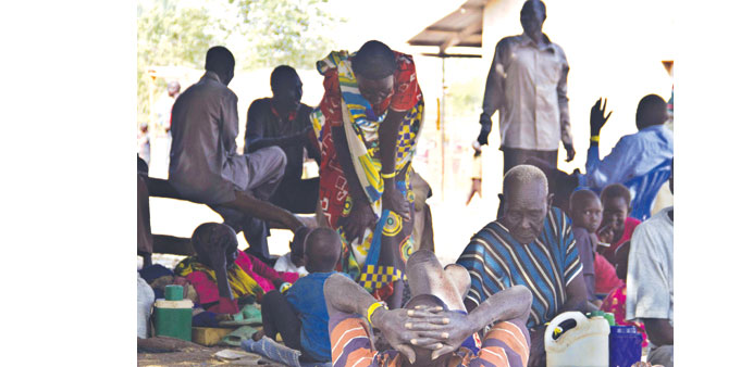 South Sudanese refugees rest in the compound of Dzaipi Health Centre yesterday.