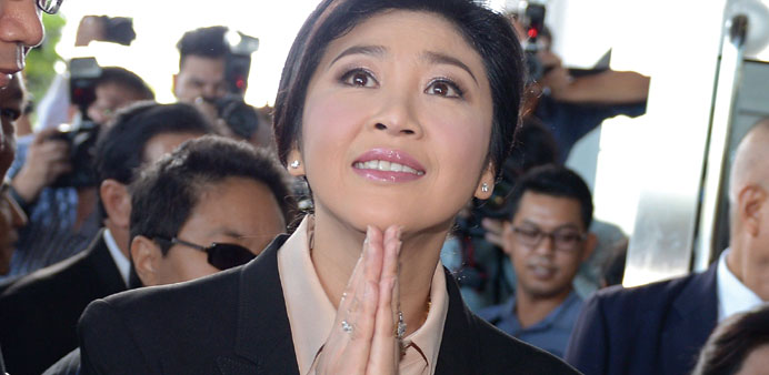 Thailandu2019s former premier Yingluck Shinawatra gives a traditional greeting to the media as she arrives at the Supreme Court in Bangkok yesterday.