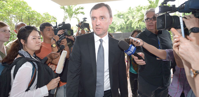 An Australian embassy representative (centre) arrives for a meeting with Indonesian officials in Jakarta yesterday, about the plan to execute two memb