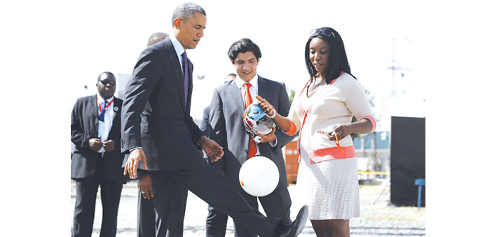 President Obama kicks a soccer ball at Ubungo Power Plant in Dar es Salaam. The ball has internal electronics that allows it to generate and store ele