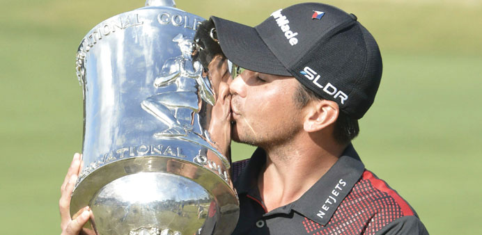 Jason Day kisses the International trophy after winning the World Cup of Golf yesterday. (EPA)