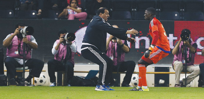 Sailiya goalkeeper Gregory Gomis (right) celebrates with a member of the training staff yesterday. PICTURES: Anas Khalid