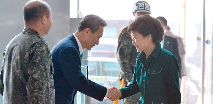 South Korean president-elect Park Geun-hye, right, shaking hands with Defence Minister Kim Kwan-jin during a visit to the Joint Chiefs of Staff  of th