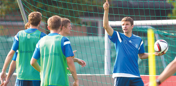 German player Thomas Mueller (right) attends a training session in Kamen, Germany ahead of their Euro qualifier against Scotland.  (AFP) 