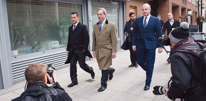 Ukip leader Nigel Farage arrives to address supporters and members of the media in central London yesterday as the party unveils its policy on immigra