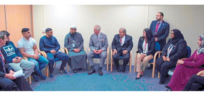 Sheikh Faisal and Prince Charles interacting with a group