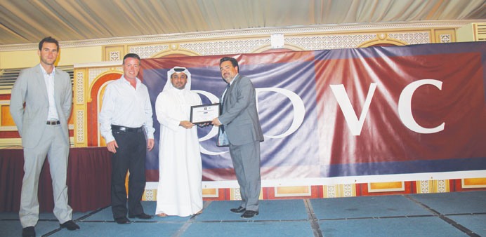 Alexandre Ambrosini receiving a safety award from Waleed al-Khal Fakhroo.
