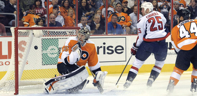 Washington Capitals left wing Jason Chimera scores a goal past Philadelphia Flyers goalie Steve Mason and  defenseman Kimmo Timonen during the second 
