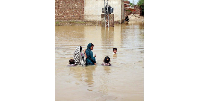 * Children wade through flood waters in Dera Allah Yar, located in the Jaffarabad district of Balochistan province. Monsoon rains have claimed around 