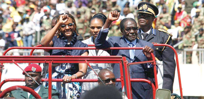 Zimbabwean President Robert Mugabe and his wife Grace salute the crowd at the National Sports Stadium for his inauguration in Harare yesterday.