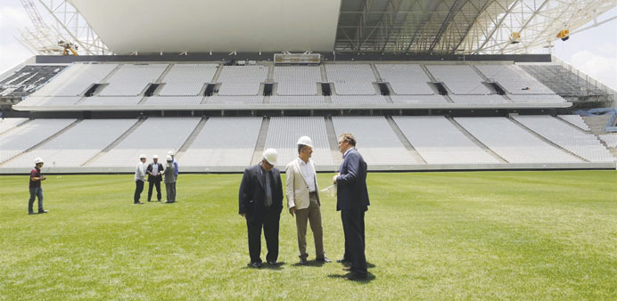 Jerome Valcke, secretary general of FIFA, right centre, and Aldo Rebelo, Brazilu2019s sports minister, centre, inspect the Itaquerao stadium in Sao Paulo.