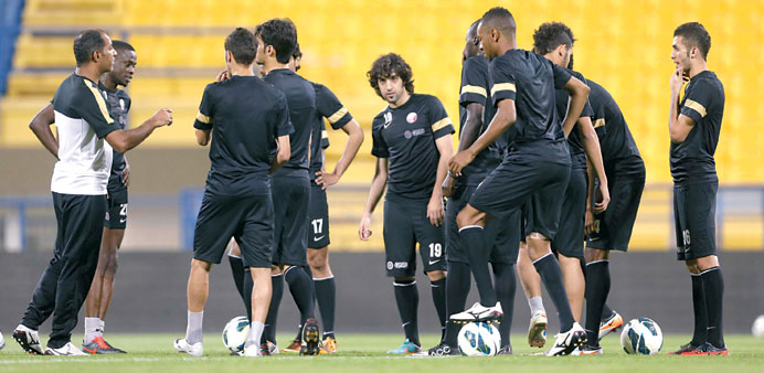 Fahad Thani speaking to his players during a training session on the eve of their friendly match against Egypt today.
