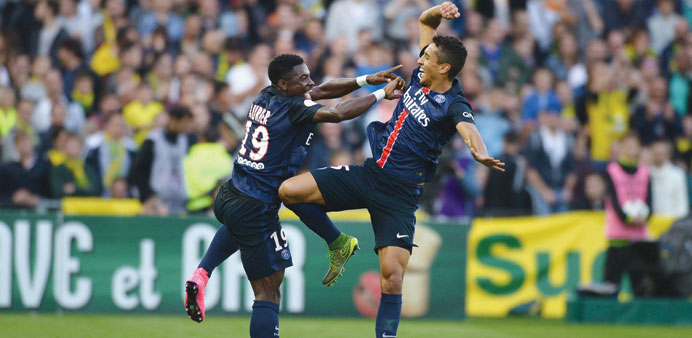 Paris Saint-Germain's Ivorian defender Serge Aurier (L) celebrates with teammate Marquinhos after scoring against Nantes last month.