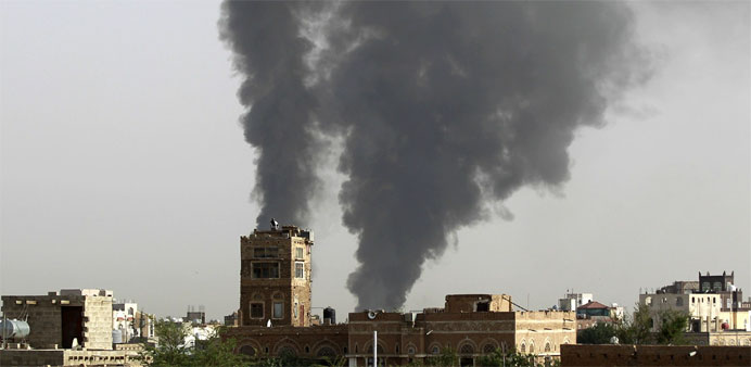 Smoke billows following air-strikes by the Saudi-led coalition on a weapons depot at a military airport