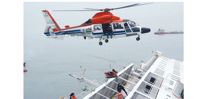 A maritime police helicopter rescues passengers from the South Korean ferry that capsized yesterday in a West Regional Headquarters Korea Coast Guard 
