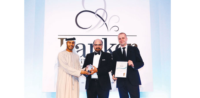 Dr R Seetharaman (centre) receives the u2018Best Regional Commercial Banku2019 award at The Banker Middle East Industry Awards.
