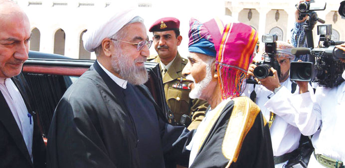 Iranian President Hassan Rohani is welcomed by Sultan Qaboos in Muscat yesterday.