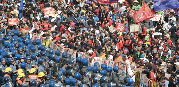 Philippine police block protesters  parading down a street in Manila trying to voice their opposition to the Apec summit.