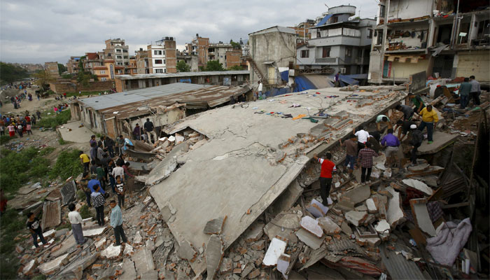 People gather near a collapsed house after a major earthquake in Kathmandu, Nepal. Reuters 
