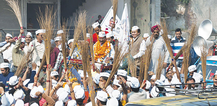 Aam Aadmi Party leader Arvind Kejriwal, (back centre) takes part in a campaign rally in New Delhi.