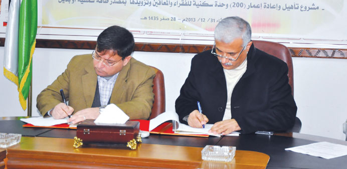 Dr Yousef al-Ghrez and Abu Halloub signing the agreement in Gaza.