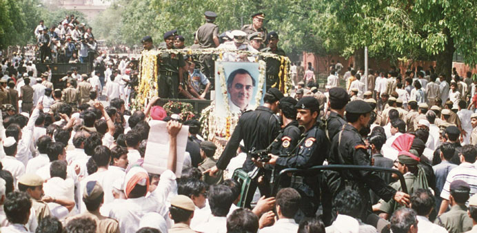 In this photograph taken on May 24, 1991, the funeral procession for slain prime minister Rajiv Gandhi moves along a crowded street in New Delhi. The 