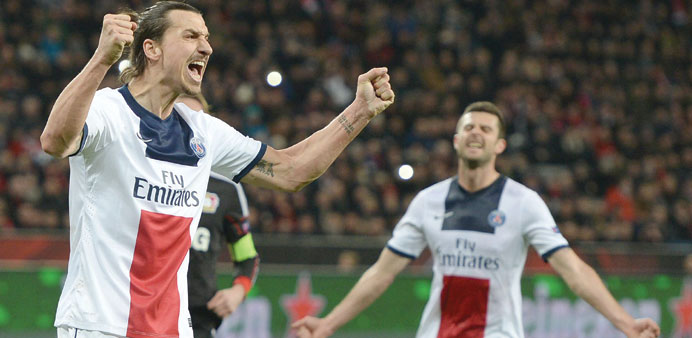 Paris Saint Germain striker Zlatan Ibrahimovic (left) celebrates scoring during the first-leg round of 16 UEFA Champions League match against Bayer 04