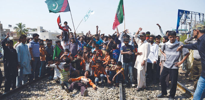 Pakistani Shia Muslims gather on the railway tracks during a protest against the bombing targeting their community in Quetta on February 16, in Karach