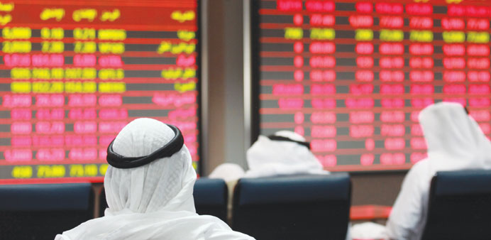 Investors follow financial information on screens inside the Qatar Exchange (file). The 20-stock Qatar Index recast will be effective from October 1, 