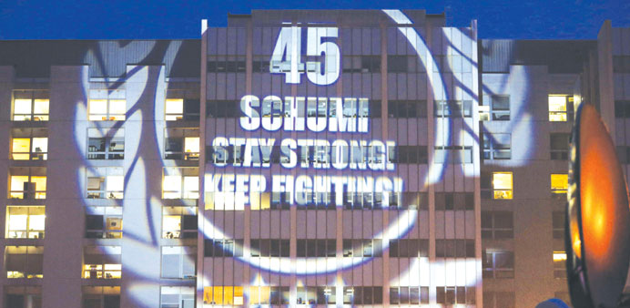 A message to mark the 45th birthday of seven-time Formula One world champion Michael Schumacher is projected by fans on the facade of the CHU hospital