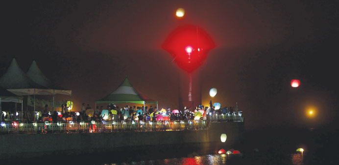 Mourners release fire balloons during a vigil for the victims of the sunken Sewol ferry at Jindo port 100 days after the disaster.