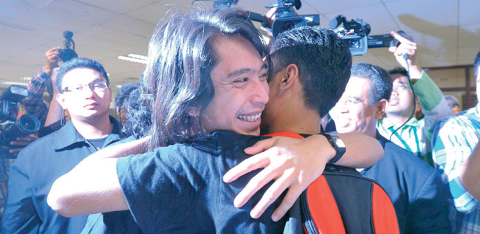 Student activist Adam Adli Abdul Halim is hugged by an unidentified friend after he was released on bail at the high court in Kuala Lumpur.