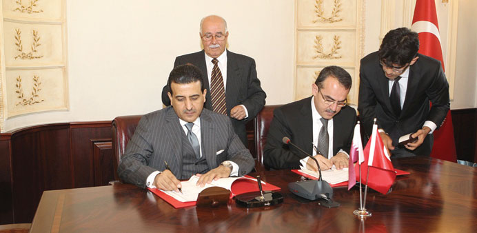 HE Dr al-Marri (left) and Ergoan signing the MoU.