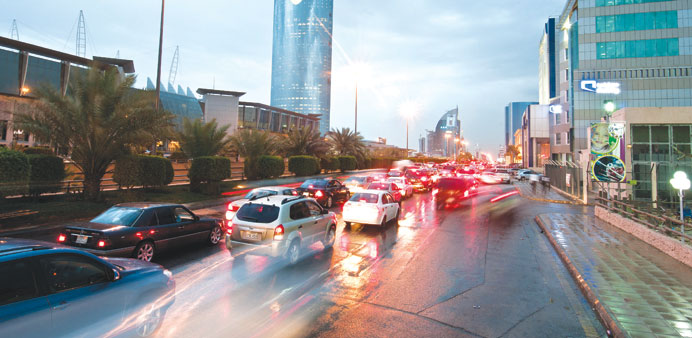 Traffic passes the Kingdom Tower on King Fahad Road in Riyadh, Saudi Arabia (file). Saudi Arabia may not be able to create all the private sector jobs