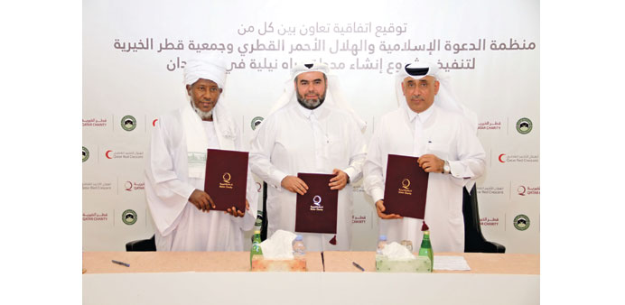 Al-Fadeni, al-Kuwari and al-Mohannadi at the agreement signing ceremony in Doha.