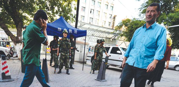 Chinese paramilitary police stand guard in the Uighur minority area of Urumqi, Xinjiang province yesterday.