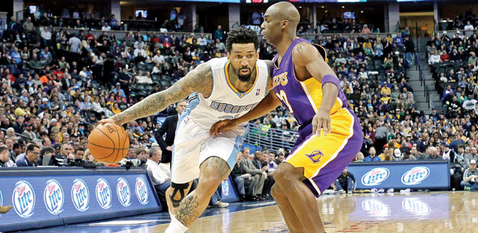 Denver Nuggets shooting guard Wilson Chandler (L) drives to the net against Los Angeles Lakers shooting guard Jodie Meeks in the second quarter of the